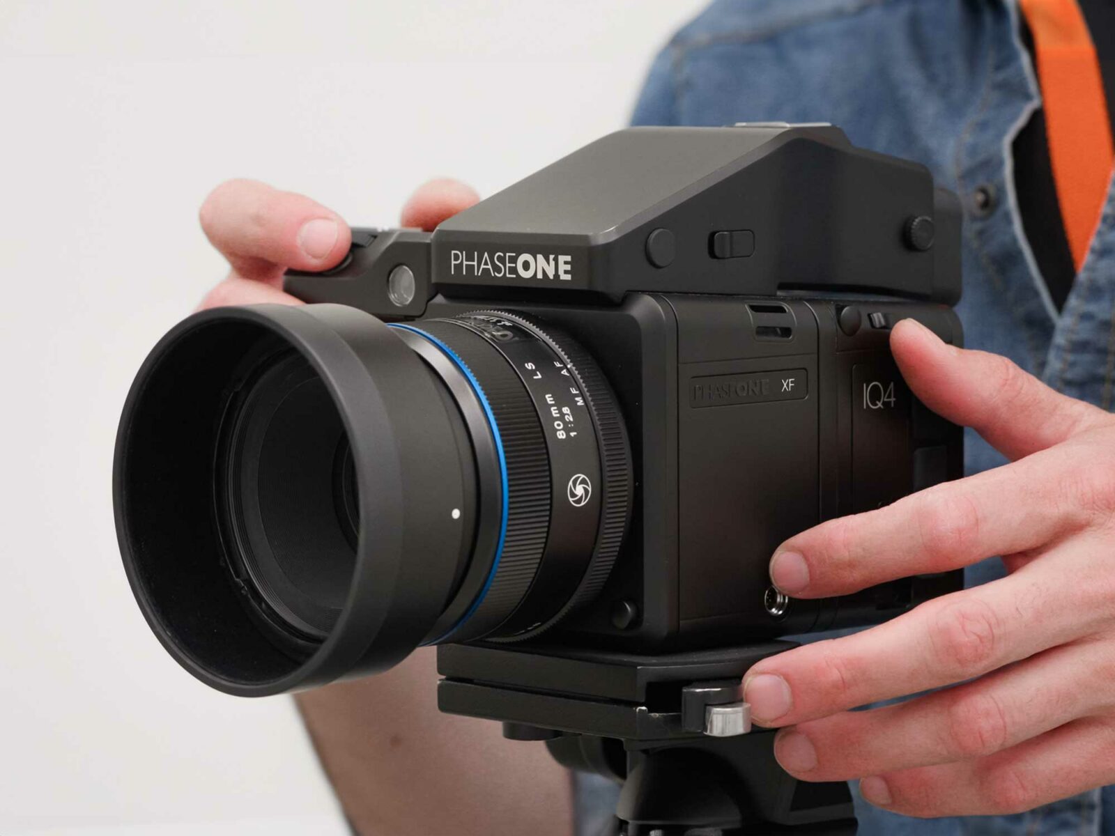 The hand of a photographer shooting a 150MP Phase One XF Medium Format Camera used for artwork digitization.