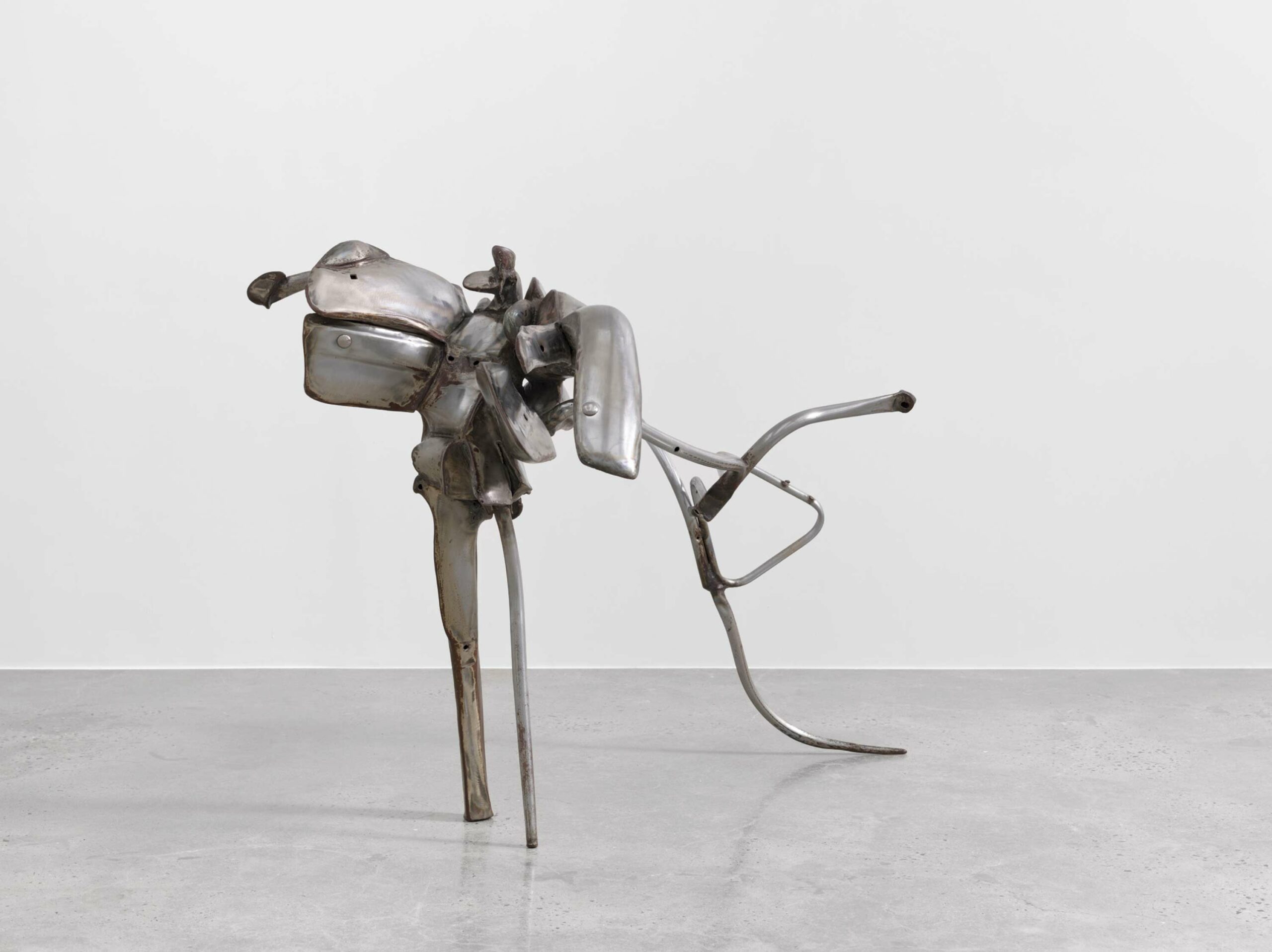 An organic metal sculpture in an art gallery